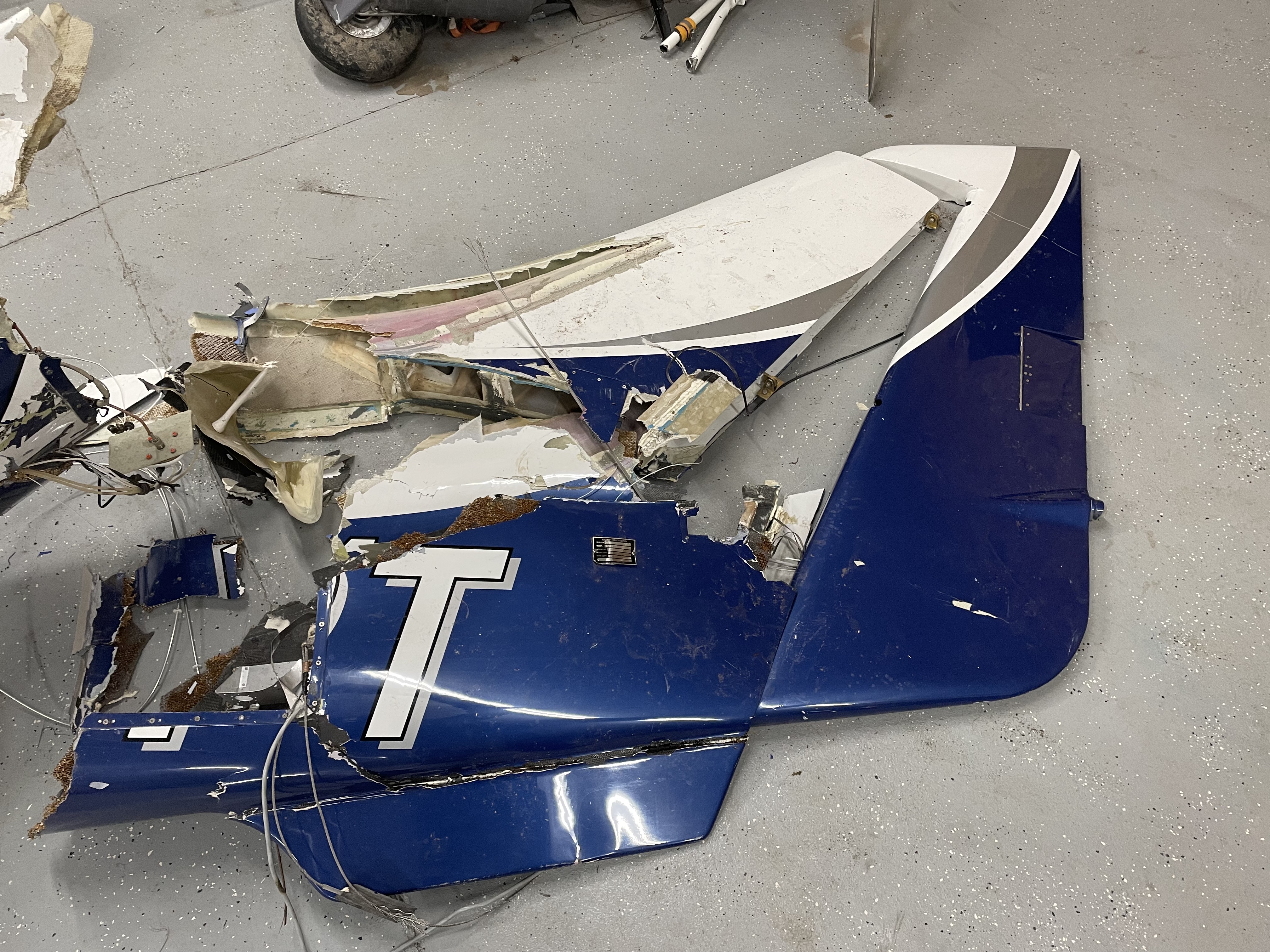 Vertical tail and rudder completely separated from plane.  Horizontal was found completely separated on its own as well.