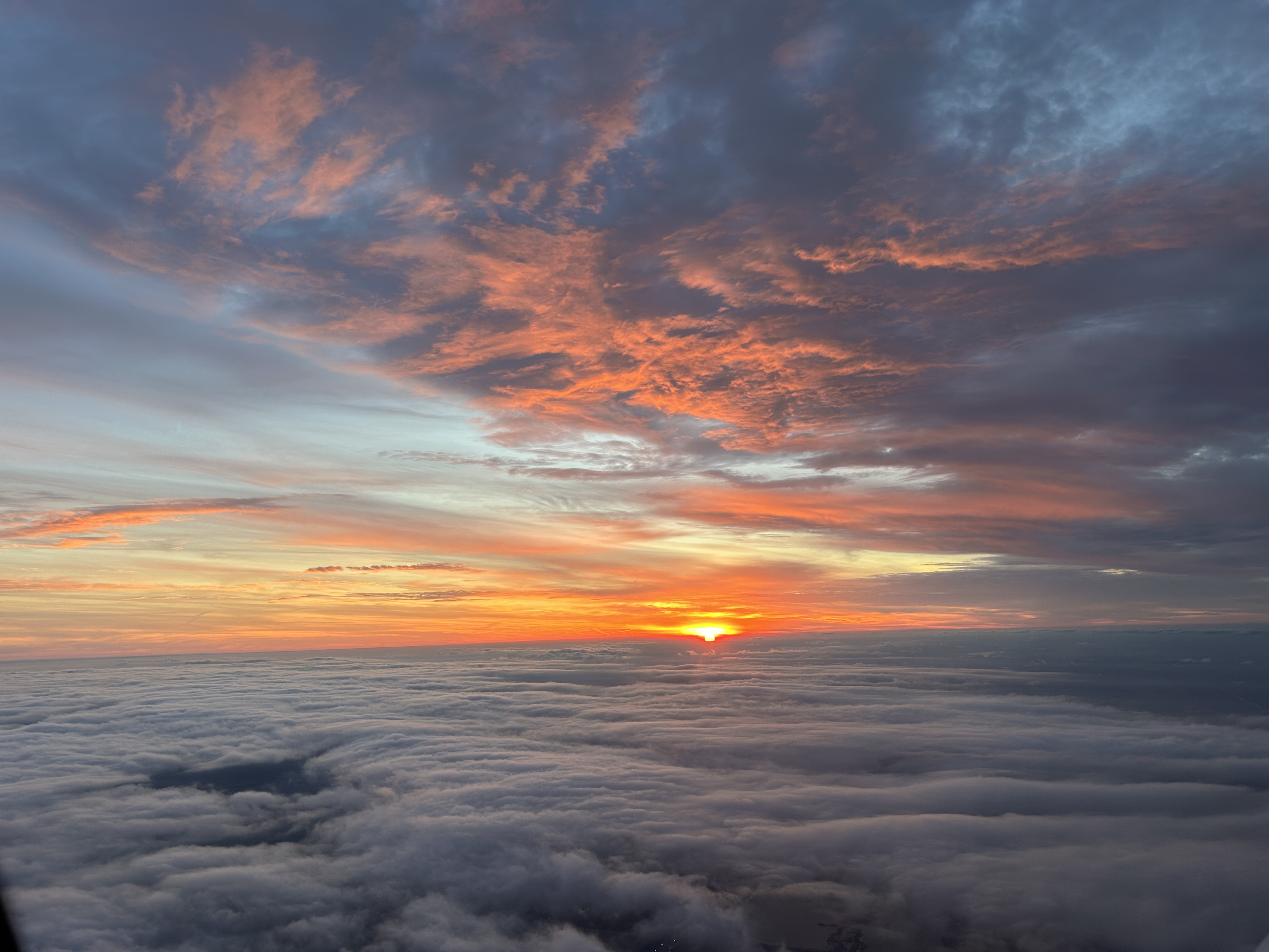 Note the beautiful sun lighting up the bottom of the upper cloud layer